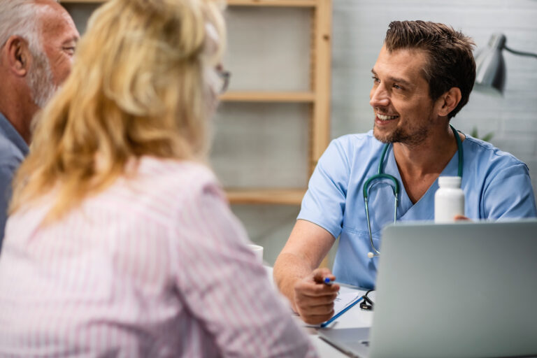 Kitchener Waterloo HL Walk In Clinic Happy Male Doctor Advising Senior Couple About Vitamins Medical Appointment His Office 768x512